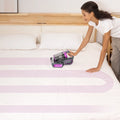 Woman using cordless vacuum to clean full mattress surface